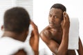 Black Man Examining Hair On Head Having Dandruff In Bathroom