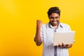 Black man excited holding laptop computer clenching fists and raising a hand for winner Royalty Free Stock Photo