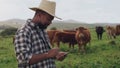 Black man, farmer and cows with tablet in agriculture, production or monitoring natural growth in countryside. African Royalty Free Stock Photo