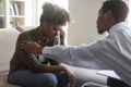 Black man psychologist comforting upset woman patient Royalty Free Stock Photo
