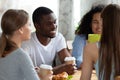 Black man and girls sitting drinking coffe chatting in cafe Royalty Free Stock Photo