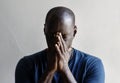 Black man with hands covered his face feeling worried Royalty Free Stock Photo