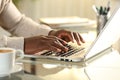 Black man hands typing on a laptop on a desk at home Royalty Free Stock Photo