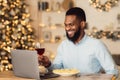 Black man having dinner drinking wine making videocall Royalty Free Stock Photo