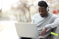 Black man with headphones e-learning using laptop Royalty Free Stock Photo