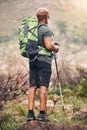 Black man, hiking and mountain with backpack for travel, adventure or trekking in the nature. African American male