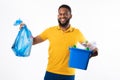 Black Man Holding Garbage Bag And Box Over White Background