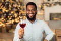 Black man holding glass of wine, looking at camera Royalty Free Stock Photo