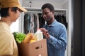 Black man inspecting fresh grocery delivery at home
