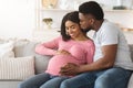 Black man kissing his happy pregnant wife Royalty Free Stock Photo