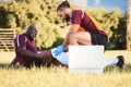 Black man, knee pain and injury, medic help athlete and sports accident on field with health and wellness. Bandage leg Royalty Free Stock Photo