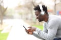 Black man listening music on headphones and phone Royalty Free Stock Photo