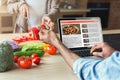 Black man looking at a recipe in laptop Royalty Free Stock Photo