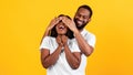 Black man making surprise for his woman, covering eyes Royalty Free Stock Photo