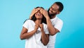 Black man making surprise for his woman, covering her eyes Royalty Free Stock Photo