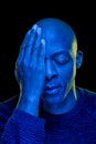 Black man with one eye covered with the hand. Blue light Royalty Free Stock Photo