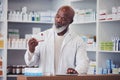 Black man, pharmacist and pill box with healthcare, prescription and tablet with medication boxes. Person, pharmacy and Royalty Free Stock Photo