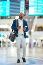 Black man with phone, airport and flight schedule, walking in terminal, holding ticket and passport for business trip Royalty Free Stock Photo