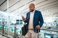 Black man with phone, airport and online check in or flight schedule in terminal for business trip. Smile, travel and Royalty Free Stock Photo