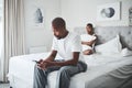 Black man, phone and bedroom with wife in bed with couple problems thinking about divorce. Mobile affair, angry and Royalty Free Stock Photo