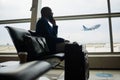 Black man, phone call and luggage at airport for business travel, trip or communication waiting for flight. African Royalty Free Stock Photo