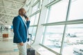 Black man, phone call and luggage at airport for business travel, trip or communication waiting for flight. African Royalty Free Stock Photo