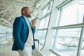 Black man, phone call and luggage at airport for business trip, travel or communication waiting for flight. African Royalty Free Stock Photo