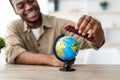 Black Man Playing With Train Model And Globe At Home Royalty Free Stock Photo