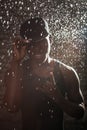 Black man in the rain on the wall background Royalty Free Stock Photo