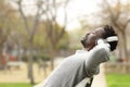 Black man relaxing on a bench listening to music Royalty Free Stock Photo