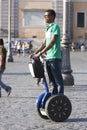 Black man riding blu segway