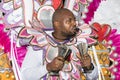 Black man ringing cowbell during the Junkanoo street festival