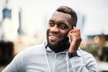 Black man runner with smartphone in a city, making a phone call. Royalty Free Stock Photo