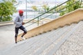 Black man running upstairs outdoors in urban background