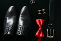 Black man`s shoes, cufflinks, wedding rings, a black belt and a Royalty Free Stock Photo