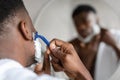 Black Man Shaving Face With Safety Razor In Bathroom, Closeup Royalty Free Stock Photo