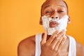 Black man with shaving foam on his face doing morning routine procedure Royalty Free Stock Photo