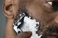 Black man shaving his beard Royalty Free Stock Photo