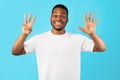 Black Man Showing Number Eight Counting On Fingers, Blue Background Royalty Free Stock Photo