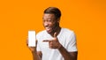 Black Man Showing Phone Blank Screen Standing, Orange Background, Mockup