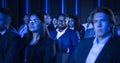 Black Man Sitting in a Crowded Audience at a Business Conference. Corporate Delegate is Focused on a Royalty Free Stock Photo