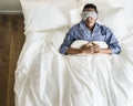 Black man sleeping on bed with eye mask Royalty Free Stock Photo