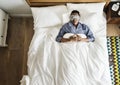 Black man sleeping on bed with eye mask Royalty Free Stock Photo