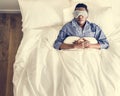 Black man sleeping on bed with eye mask Royalty Free Stock Photo