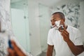 Black man, smile and shaving with razor, foam or grooming in mirror for self care in home bathroom. African guy, soap or Royalty Free Stock Photo