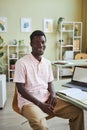 Black man smiling at camera at desk in office Royalty Free Stock Photo