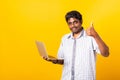 Black man smiling standing wear shirt using laptop computer and showing thumb up Royalty Free Stock Photo