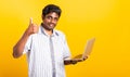 Black man smiling standing wear shirt using laptop computer and showing thumb up Royalty Free Stock Photo