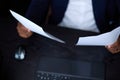 Black man studies documents on two sheets that he holds in his hands Royalty Free Stock Photo