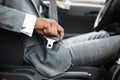 Black man in suit fasten seat belt in his car Royalty Free Stock Photo